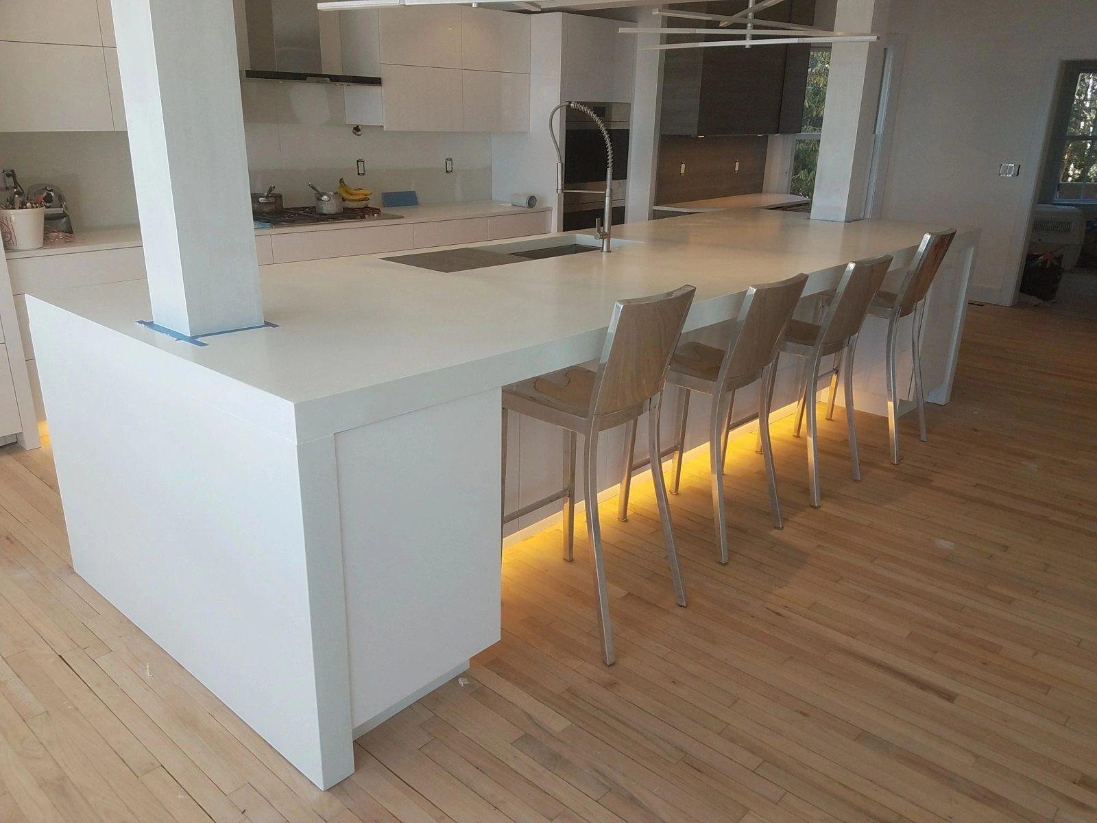 Elegant white waterfall concrete kitchen island